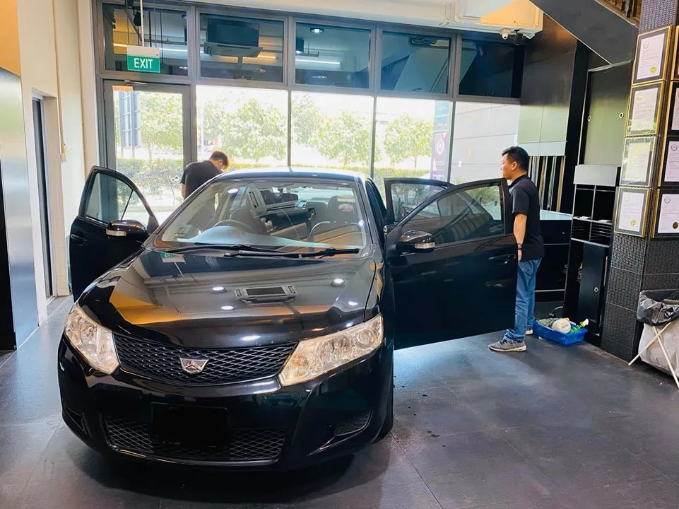 Black Toyota sedan with door open before window tinting at Infratint Singapore
