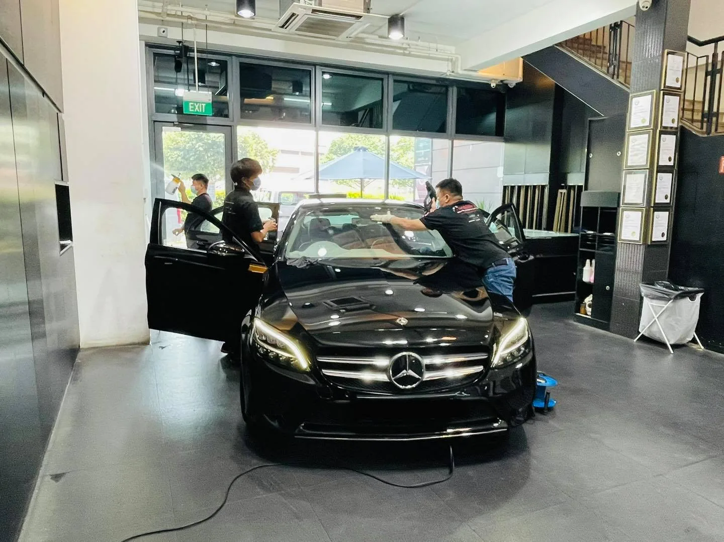 Black Mercedes-Benz sedan with doors open during window tinting at Infratint Singapore