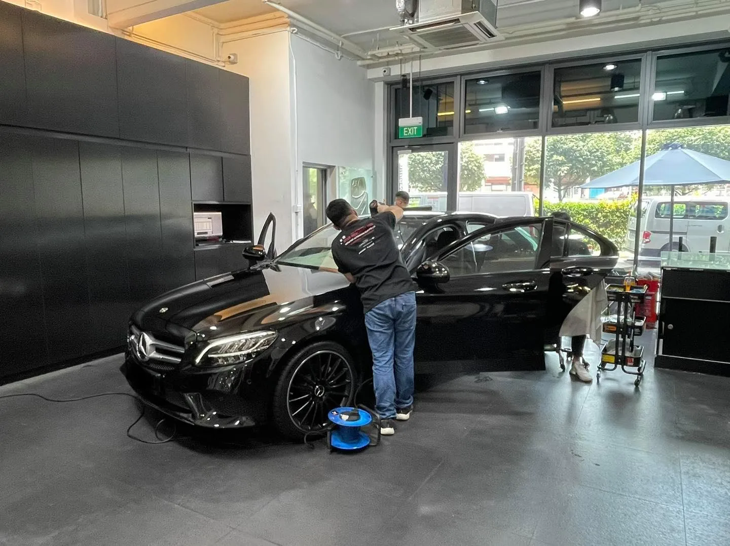 Black Mercedes-Benz sedan side glass being tinted at Infratint Singapore