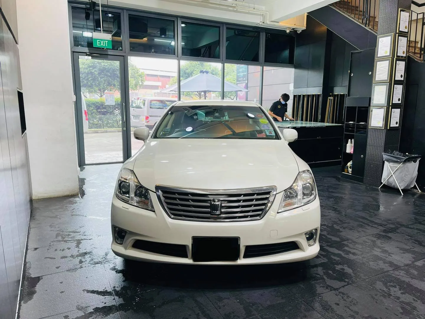 White Toyota Crown sedan front view in the showroom at Infratint Singapore