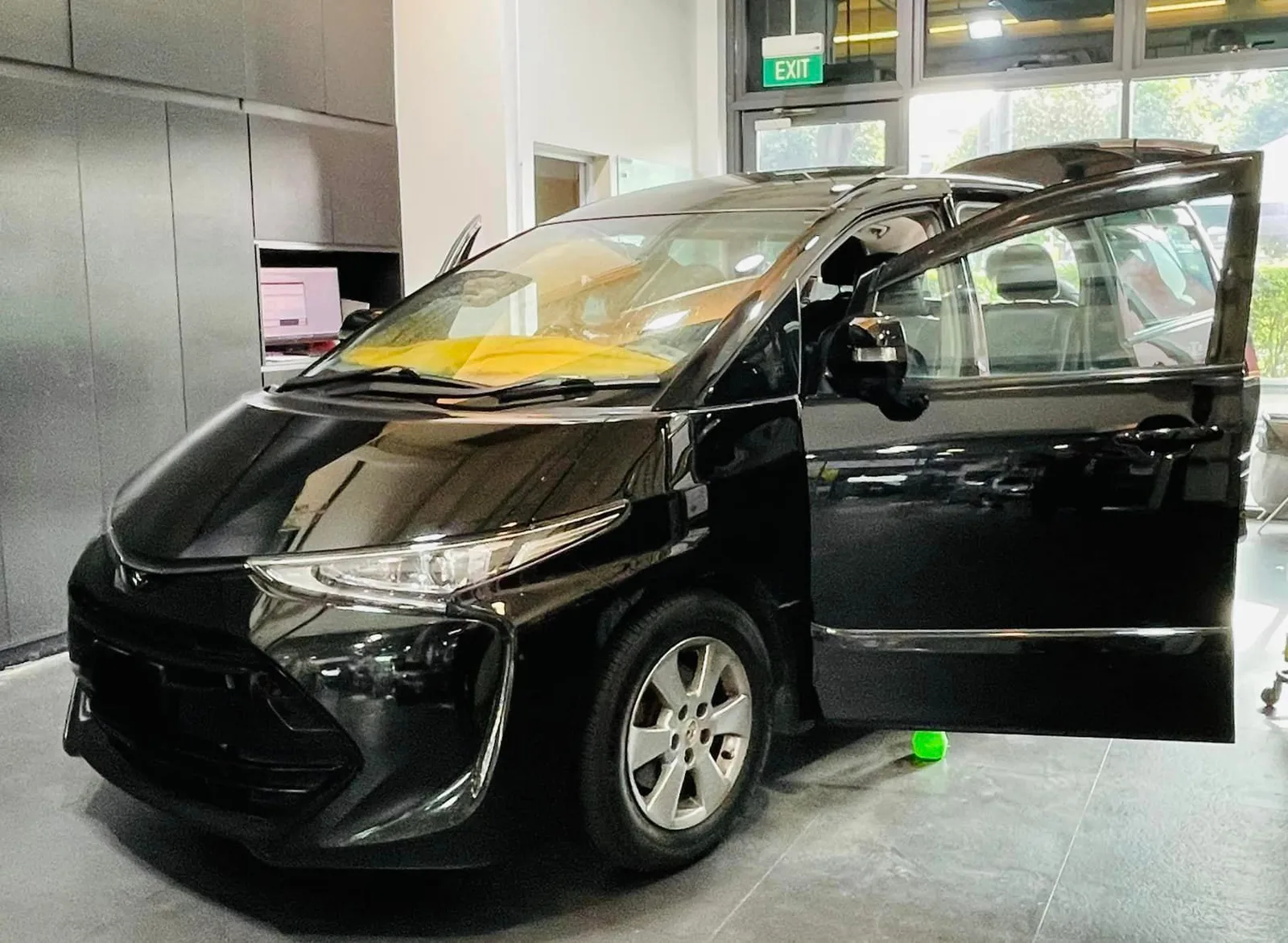 Black Toyota Estima side view with sliding door open at Infratint Singapore