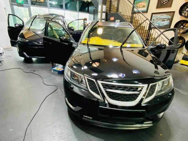 Black Saab 9-3 sedan inside the Infratint Singapore workshop