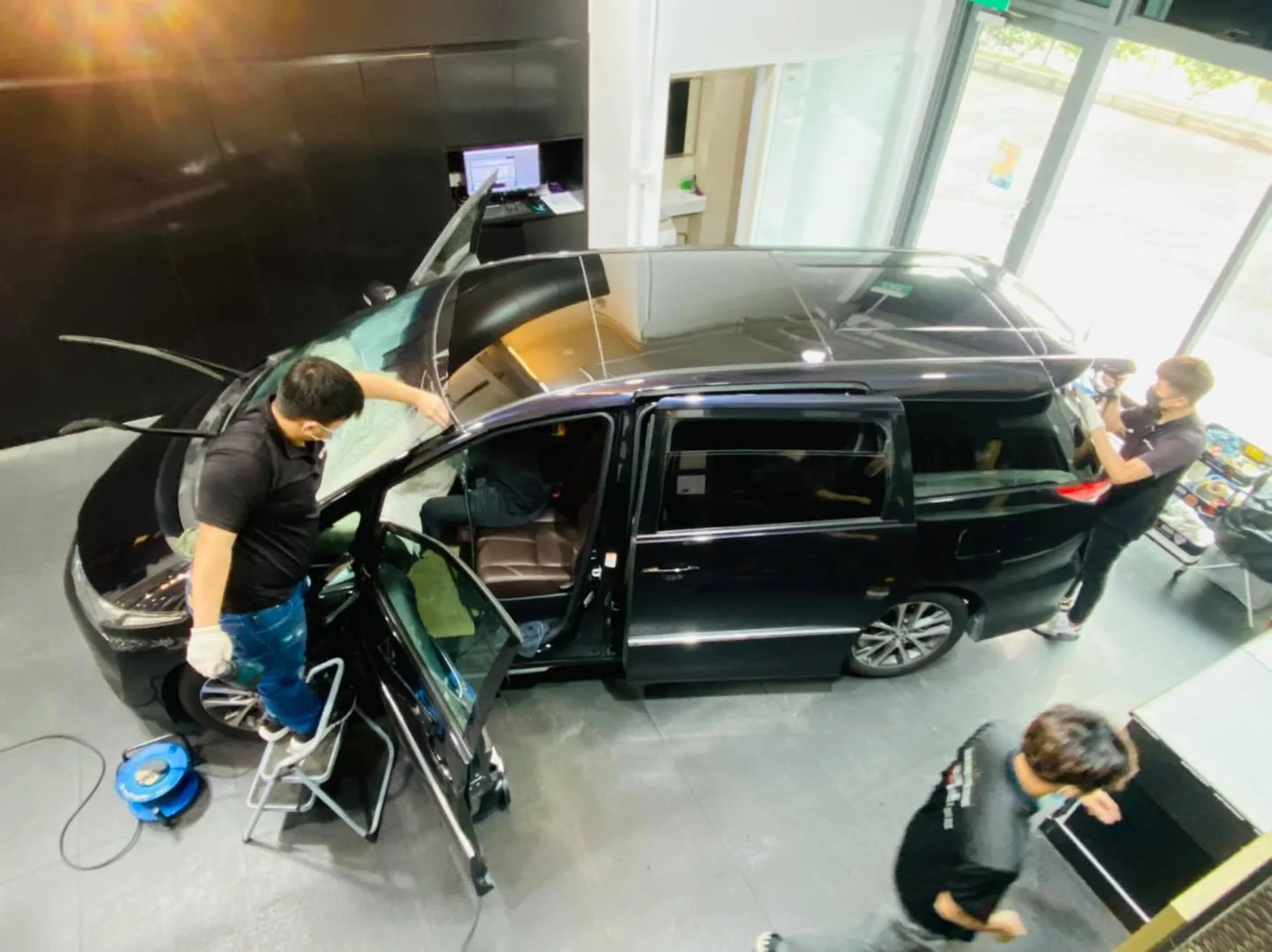 Overhead view of a black Toyota Estima being tinted by the team at Infratint Singapore