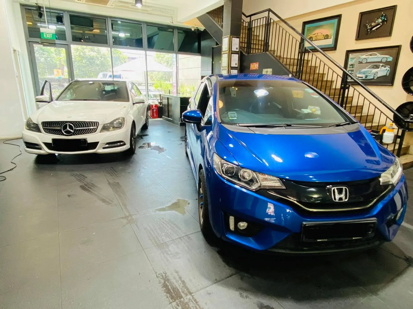 Blue Honda Fit and white Mercedes-Benz C-Class at Infratint Singapore