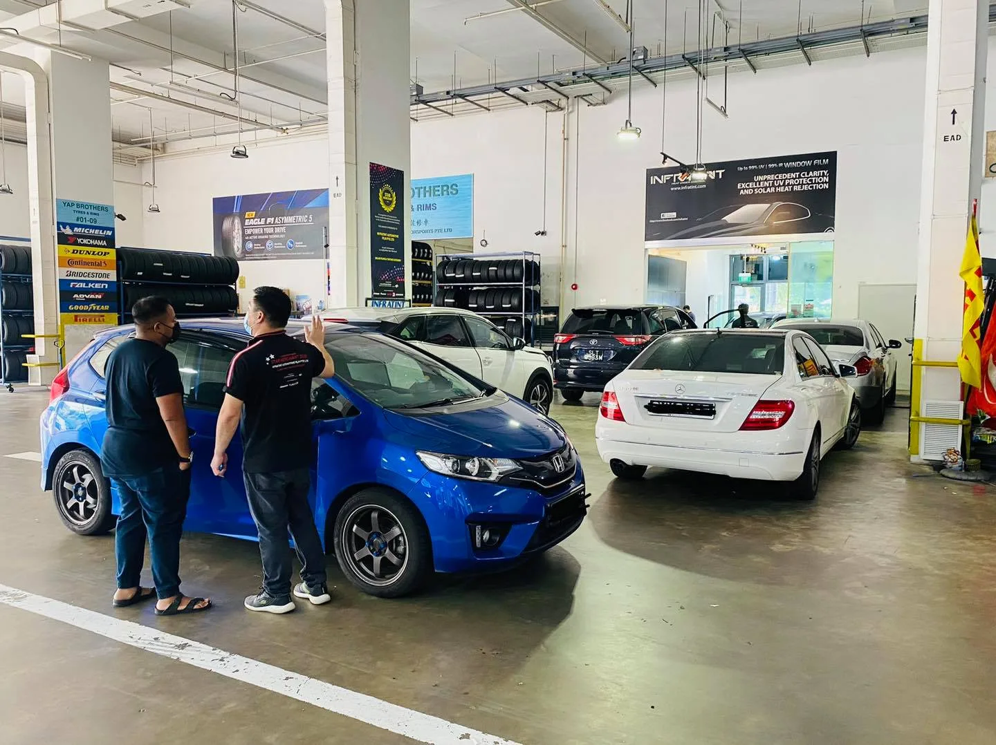 Blue Honda Fit hatchback with customers at Infratint Singapore