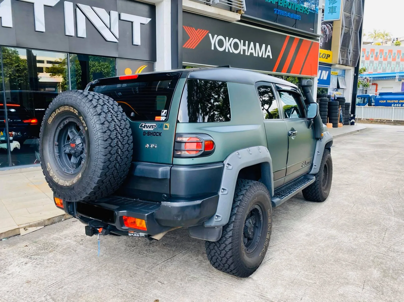 Rear view of a green Toyota FJ Cruiser with spare tyre at Infratint Singapore