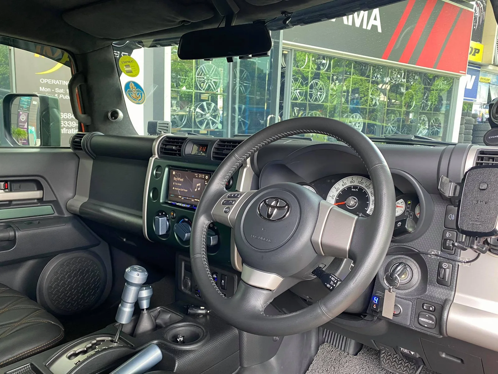 Interior dashboard and steering wheel of a Toyota FJ Cruiser at Infratint Singapore
