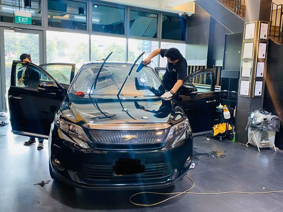 Black Toyota Harrier having its windscreen tint squeegeed at Infratint Singapore