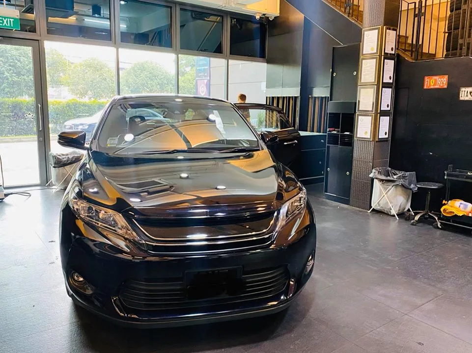 Black Toyota Harrier front view inside the Infratint Singapore showroom for window tinting
