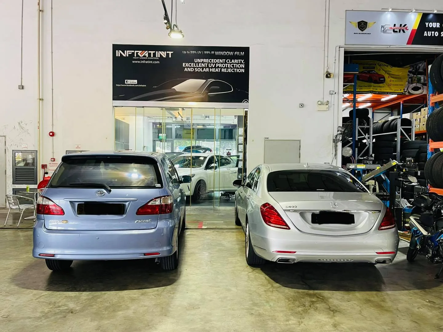 Light blue Toyota wagon and silver Mercedes-Benz S-Class from the rear at Infratint Singapore
