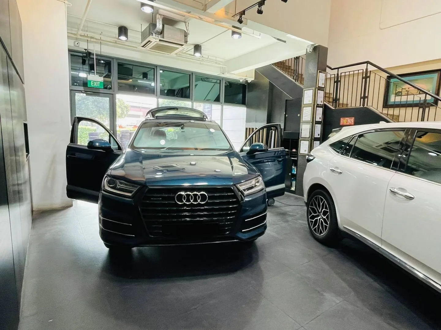 Navy Audi Q7 with door open during window film install at Infratint Singapore