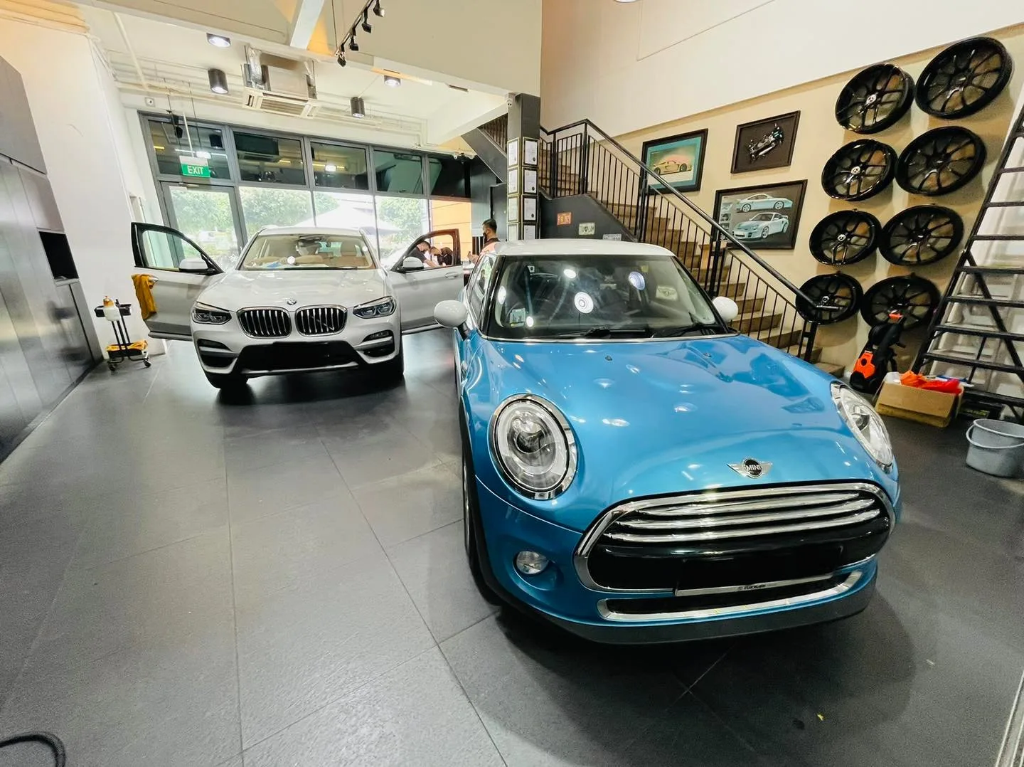 Light blue Mini Cooper and white BMW SUV inside the Infratint Singapore showroom