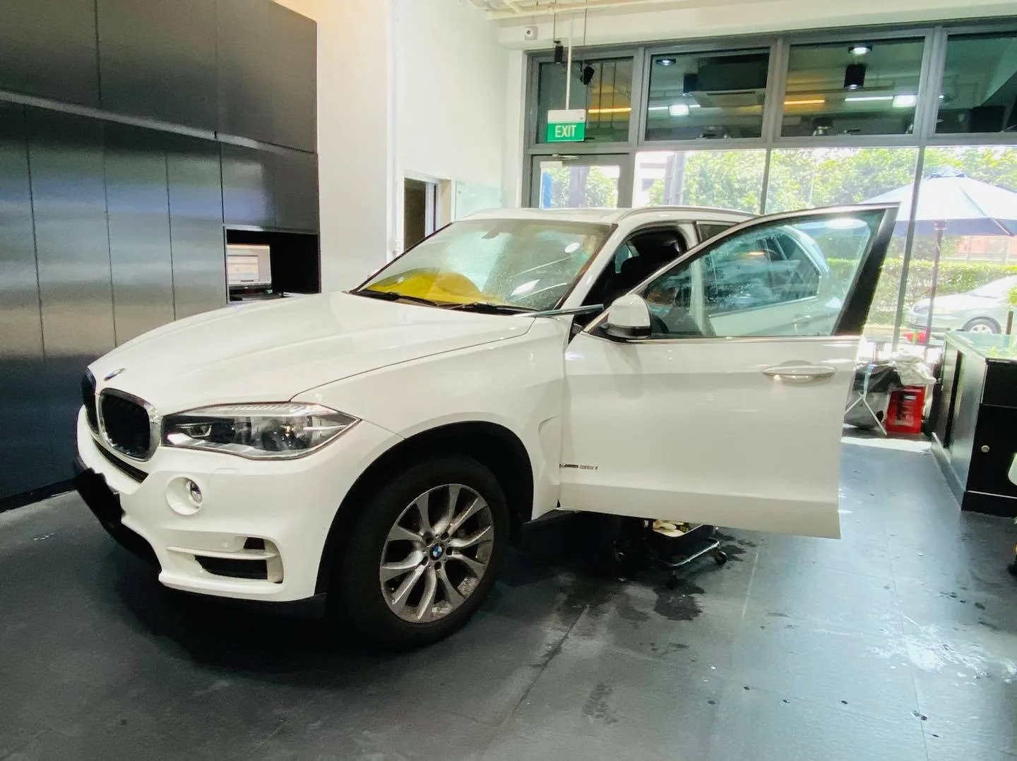 White BMW SUV with door open during window tinting at Infratint Singapore