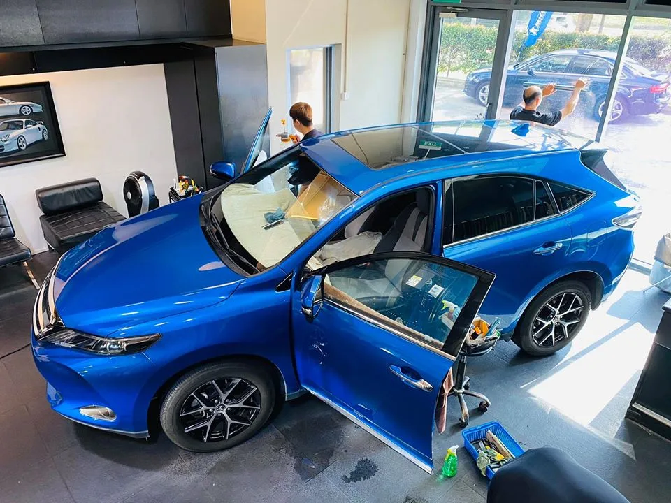 Overhead view of a blue Toyota Harrier having window film applied at Infratint Singapore