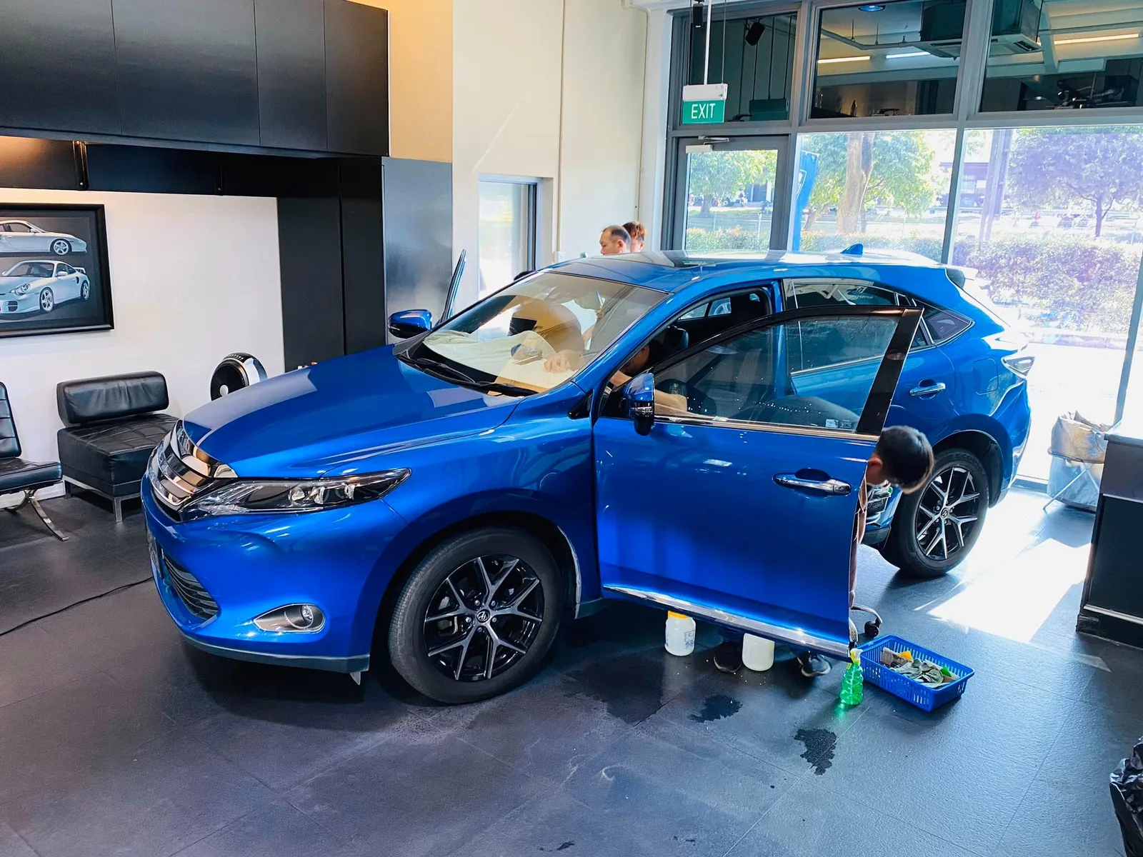 Blue Toyota Harrier SUV side view during window film install at Infratint Singapore