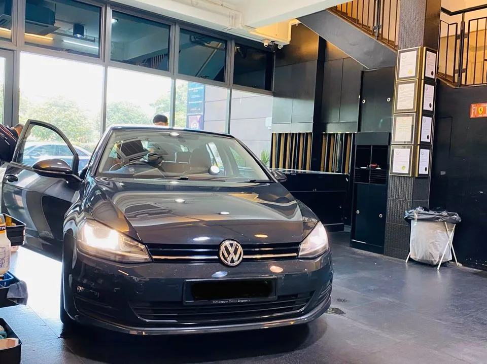 Dark Volkswagen Golf hatchback in the showroom at Infratint Singapore