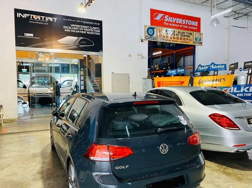 Grey Volkswagen Golf and silver Mercedes-Benz sedan at Infratint Singapore for tinting