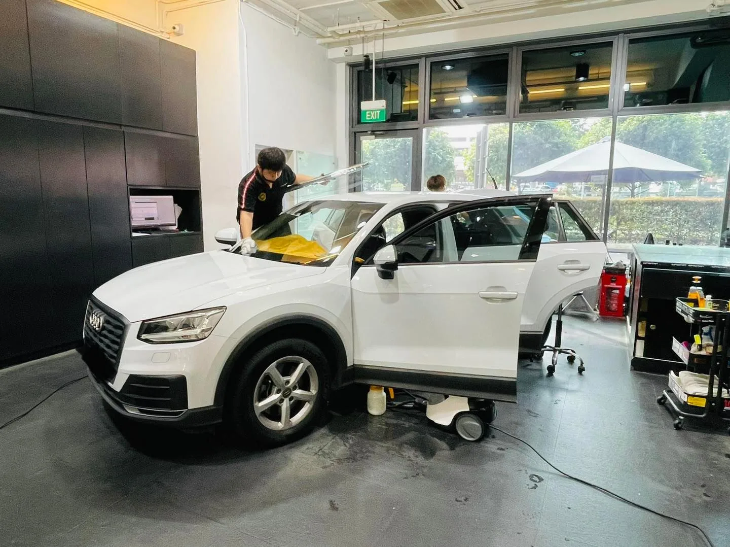 White Audi Q2 side view with open door during tinting at Infratint Singapore