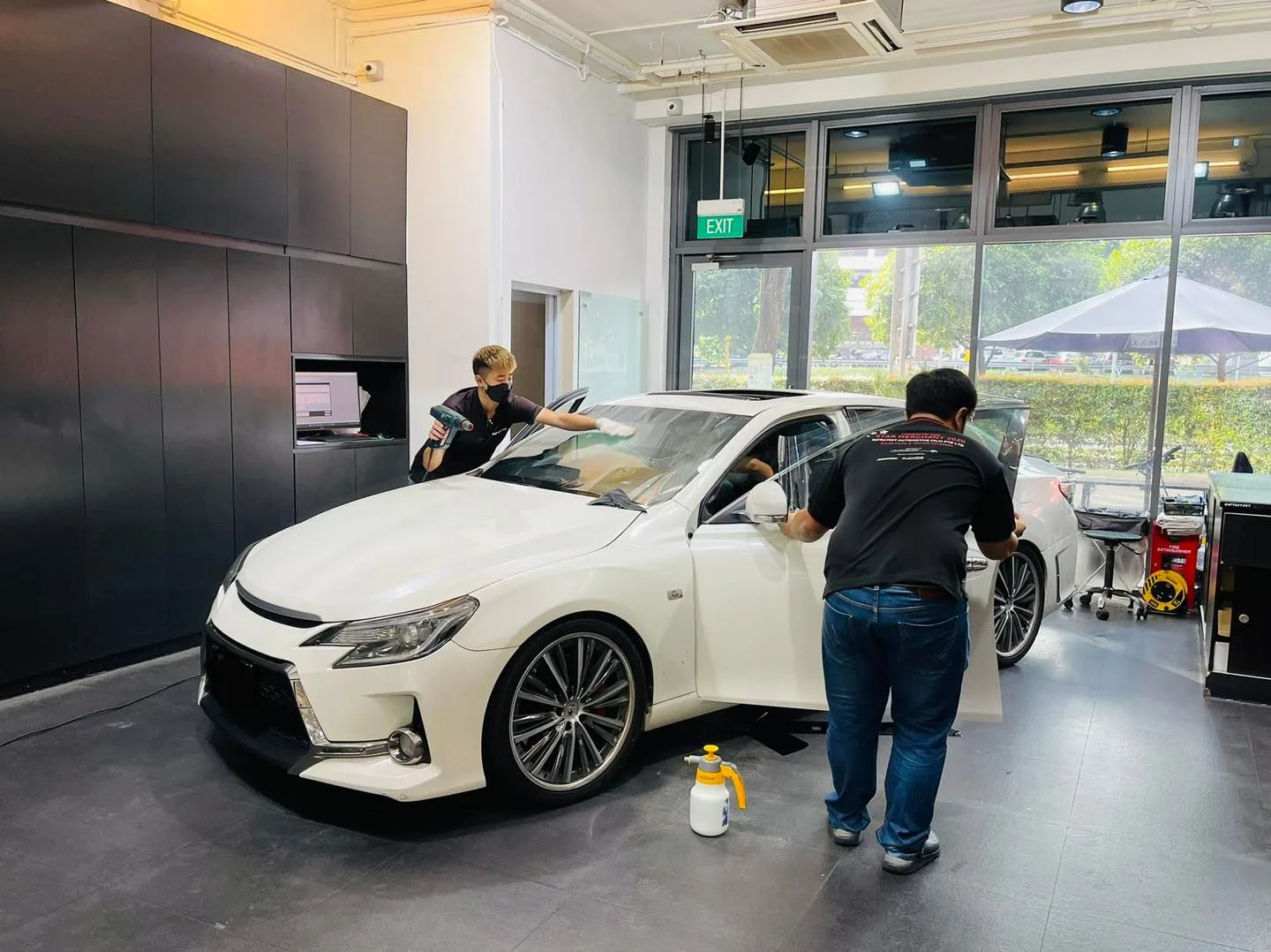 White Toyota Mark X front three-quarter during window tinting at Infratint Singapore