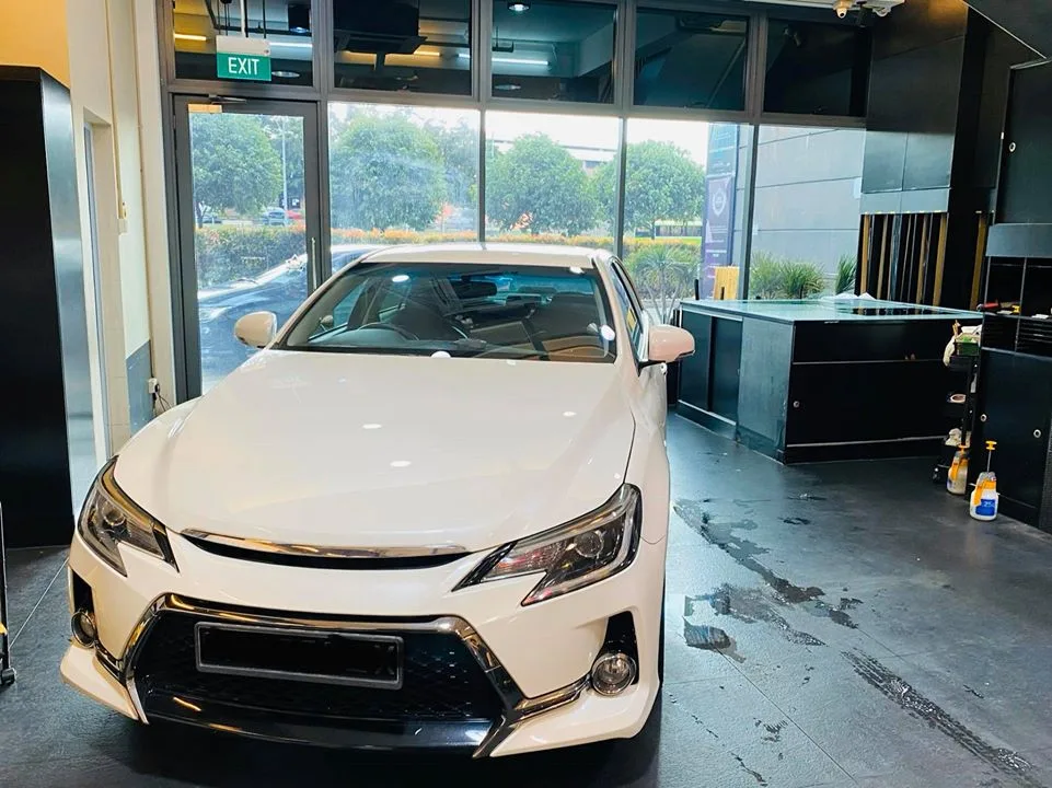 White Toyota Mark X sedan front view at Infratint Singapore for window tinting