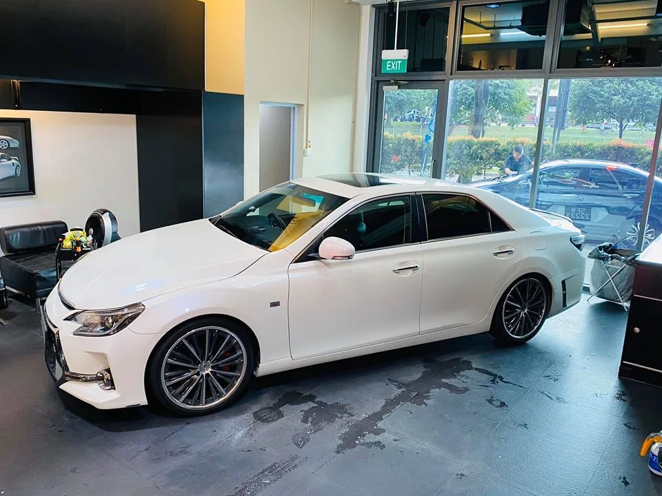 Side profile of a white Toyota Mark X sedan with tinted windows at Infratint Singapore