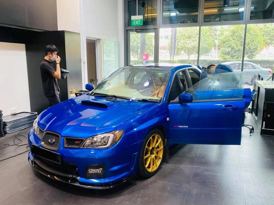 Blue Subaru WRX STI with gold wheels at Infratint Singapore for tinting