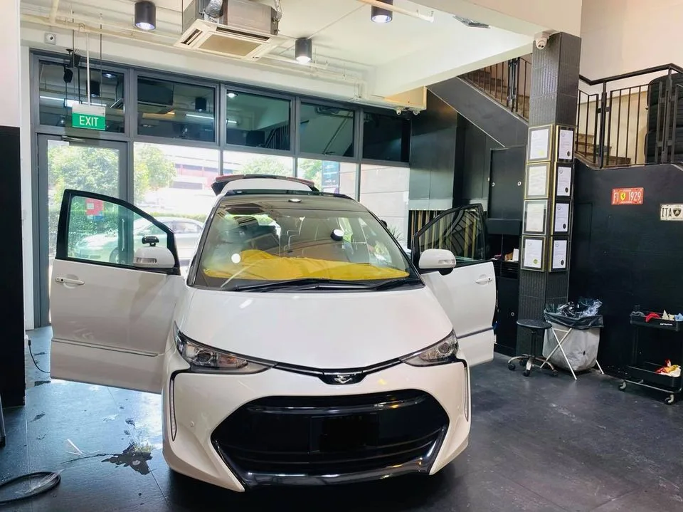White Toyota Estima MPV prepped for window film at Infratint Singapore