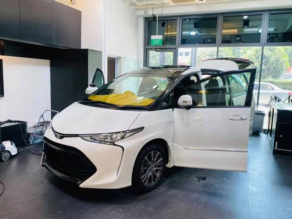 White Toyota Estima MPV doors open for tinting at Infratint Singapore
