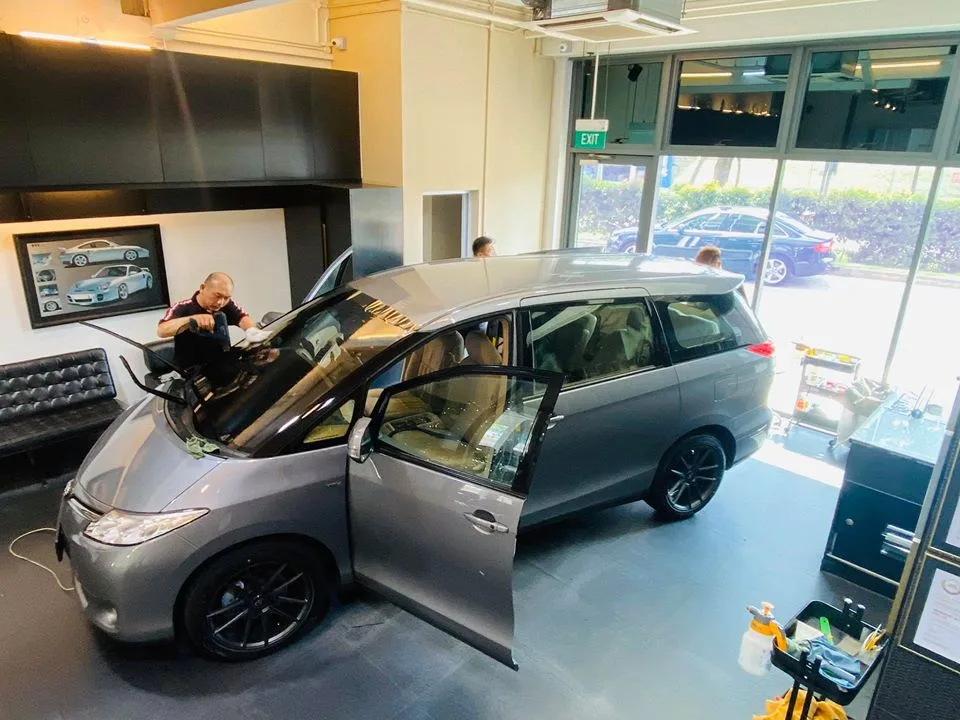 Silver Toyota Previa with sliding doors open during window tinting at Infratint Singapore
