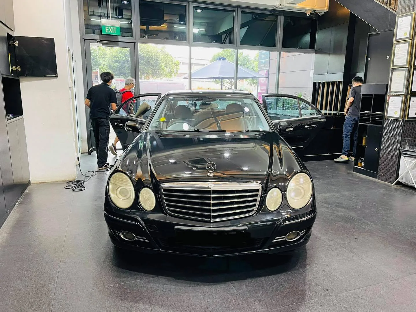 Black Mercedes-Benz E-Class sedan in the install bay at Infratint Singapore for window film