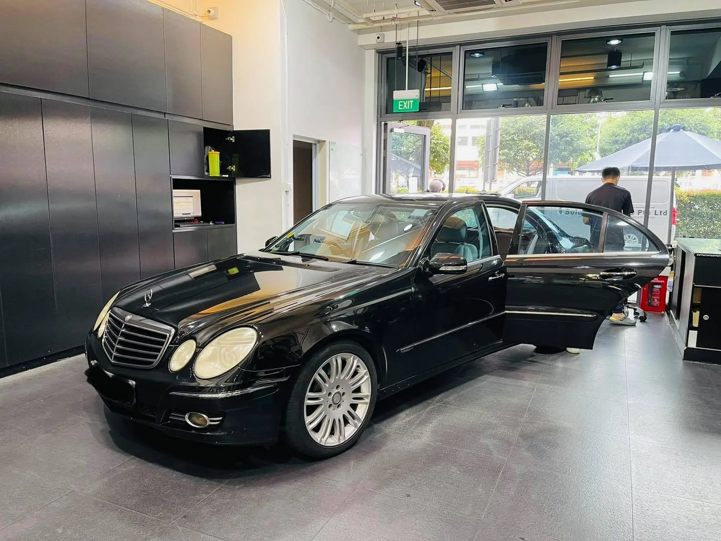 Black Mercedes-Benz E-Class sedan during window tinting at Infratint Singapore