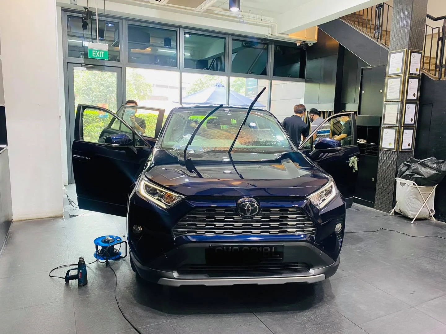 Dark blue Toyota RAV4 front view with doors open at Infratint Singapore