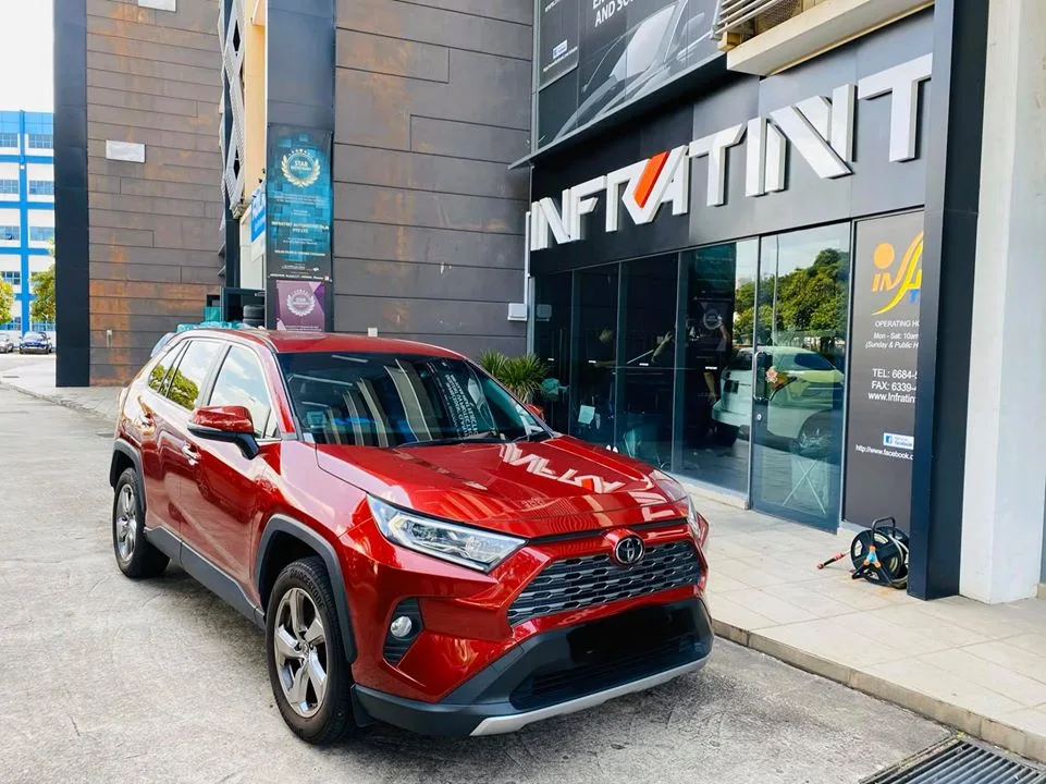 Red Toyota RAV4 SUV at the Infratint Singapore shopfront after window tinting