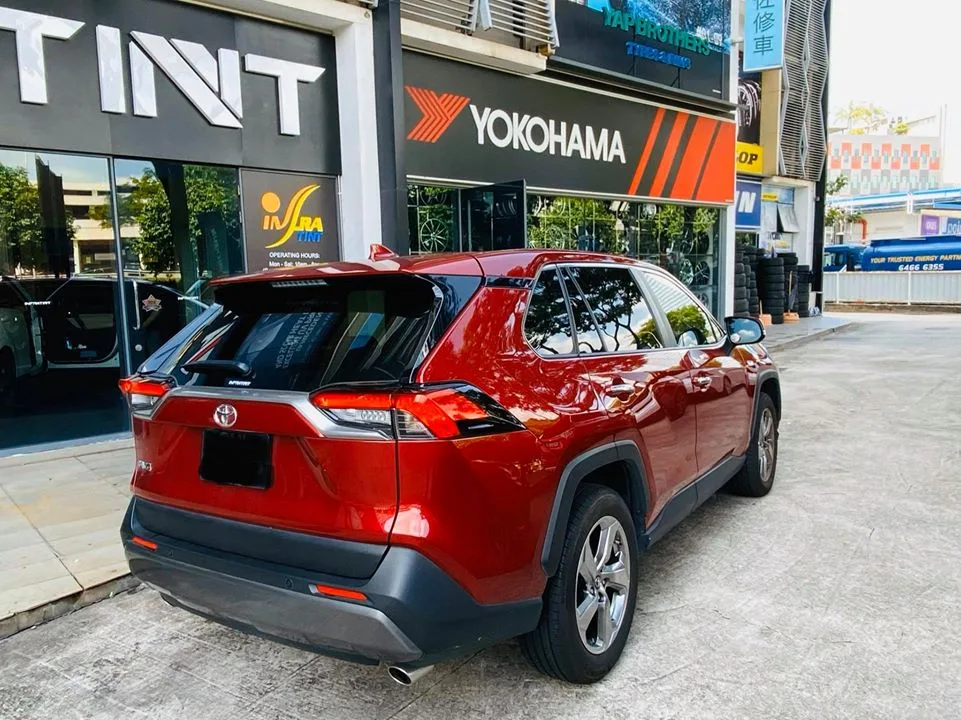 Rear three-quarter view of a red Toyota RAV4 with tinted windows at Infratint Singapore