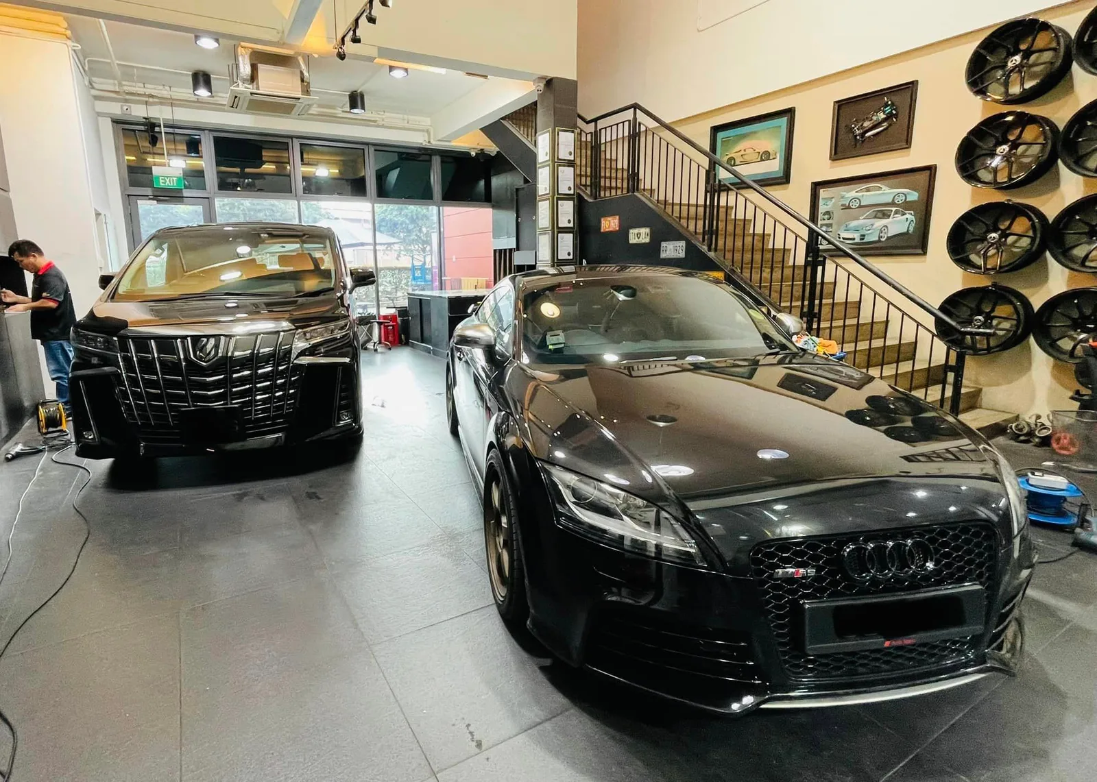 Black Toyota Alphard and black Audi TT inside the Infratint Singapore showroom
