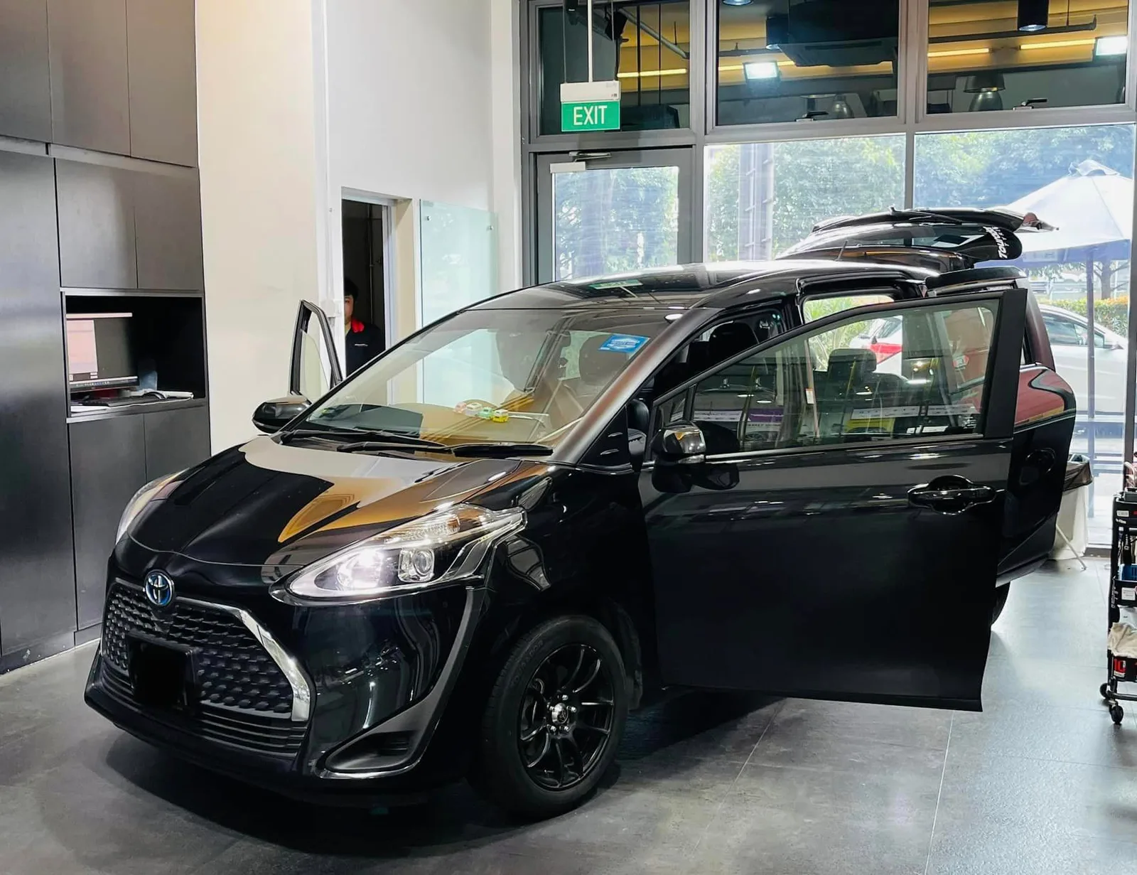 Black Toyota MPV during window film installation at Infratint Singapore