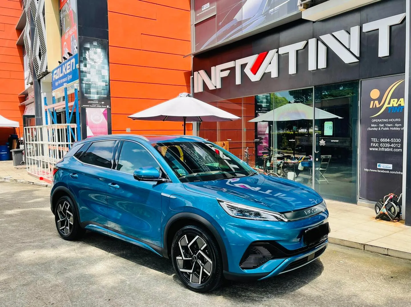 Blue BYD Atto 3 parked outside the Infratint Singapore shopfront after tinting