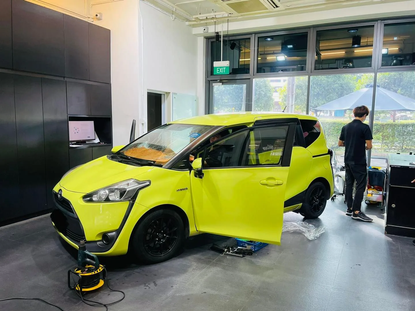 Lime green Toyota Sienta side view in the Infratint Singapore install bay
