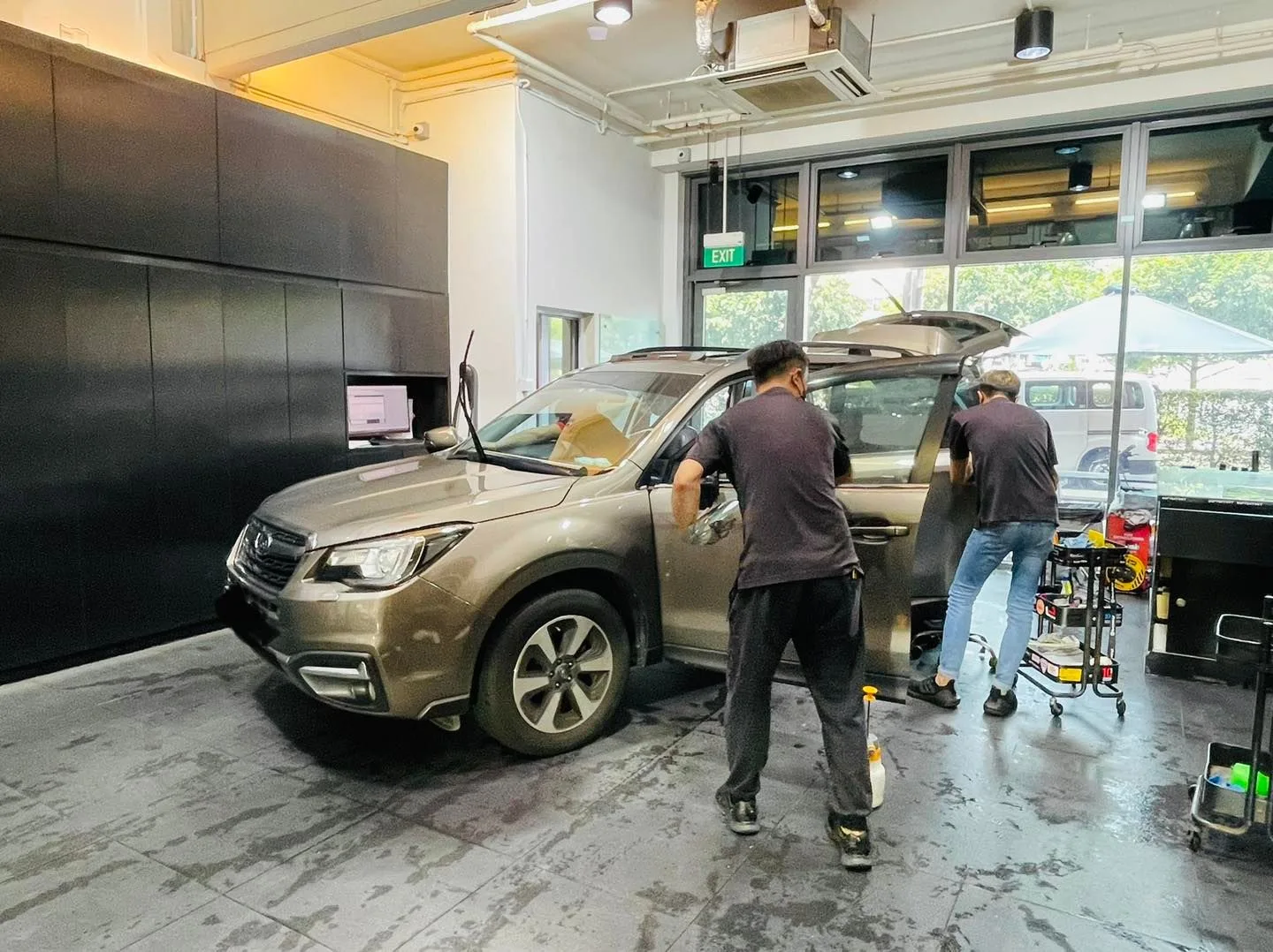 Bronze Subaru Forester being tinted by two technicians at Infratint Singapore