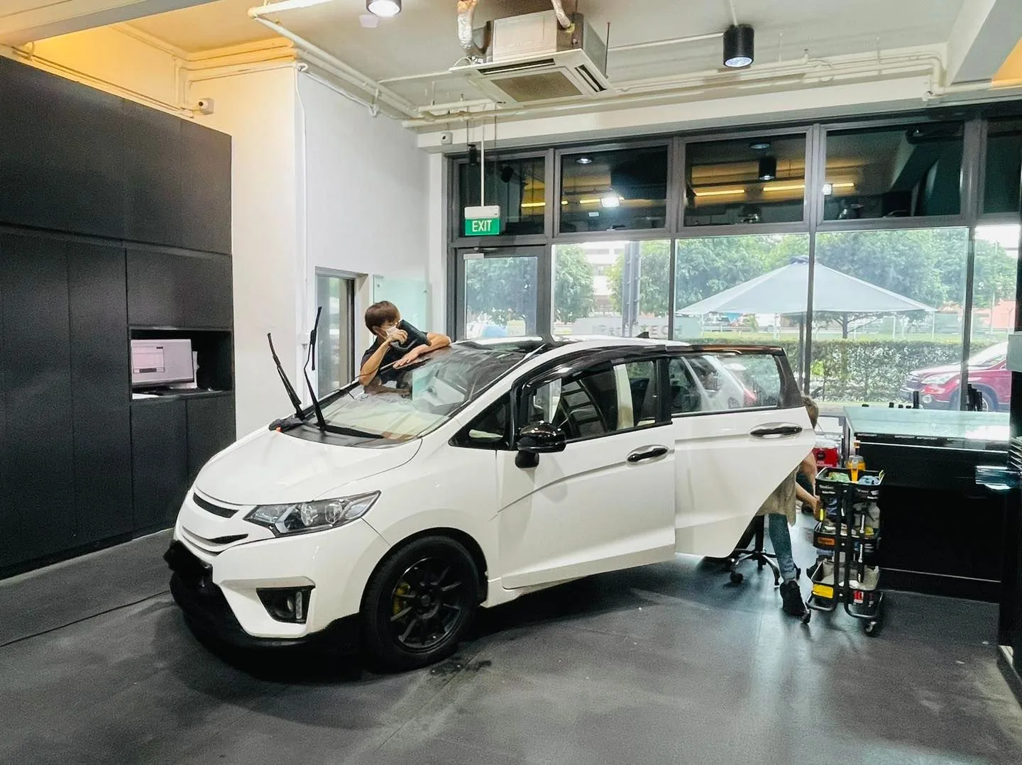 White Honda hatchback during windscreen tinting at Infratint Singapore