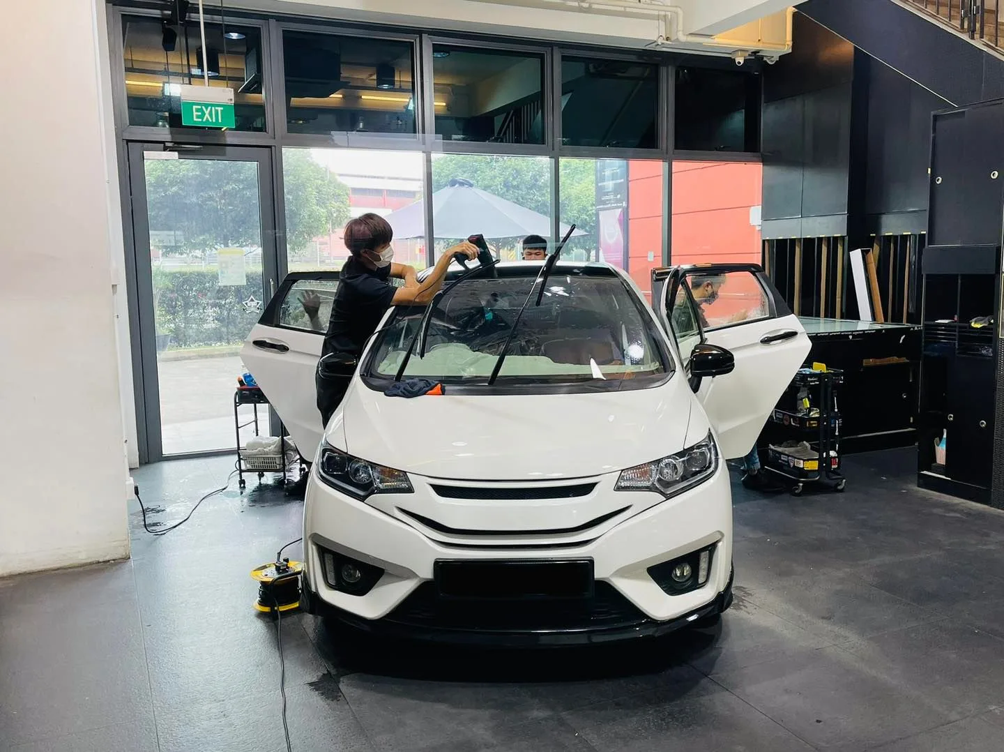 White Honda hatchback having its windscreen tinted at Infratint Singapore