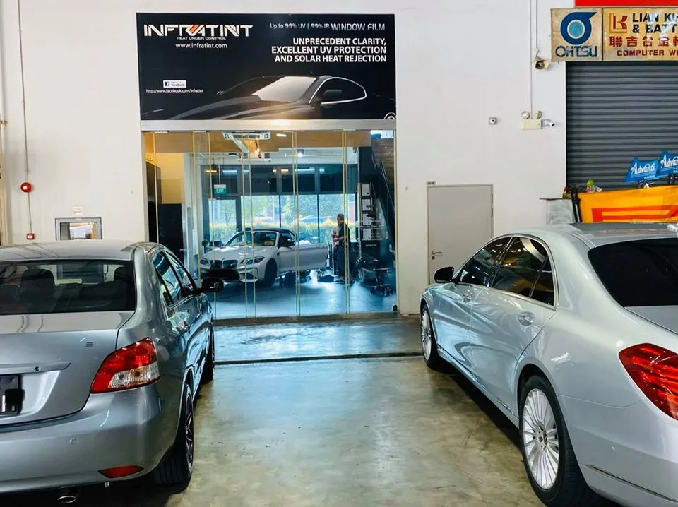 Silver Toyota and Mercedes-Benz S-Class beside the glass install bay at Infratint Singapore