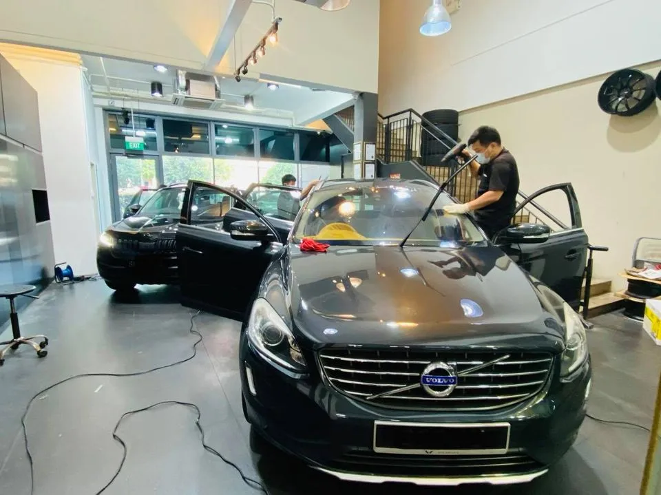 Installer applying window film to a black Volvo XC60 at Infratint Singapore