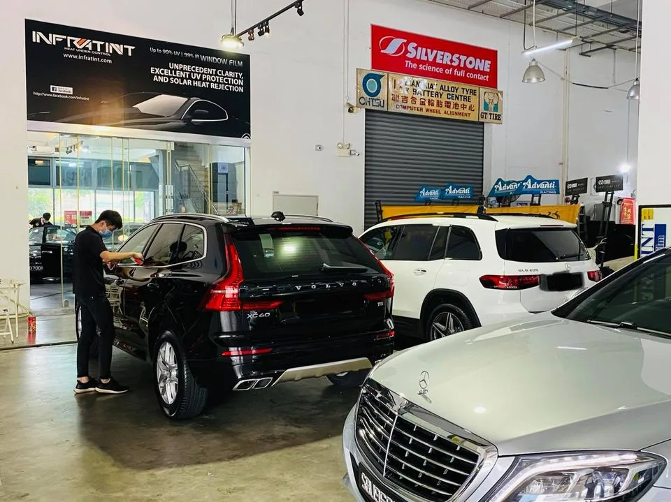 Black Volvo XC60 and silver Mercedes-Benz S-Class at Infratint Singapore window tinting workshop