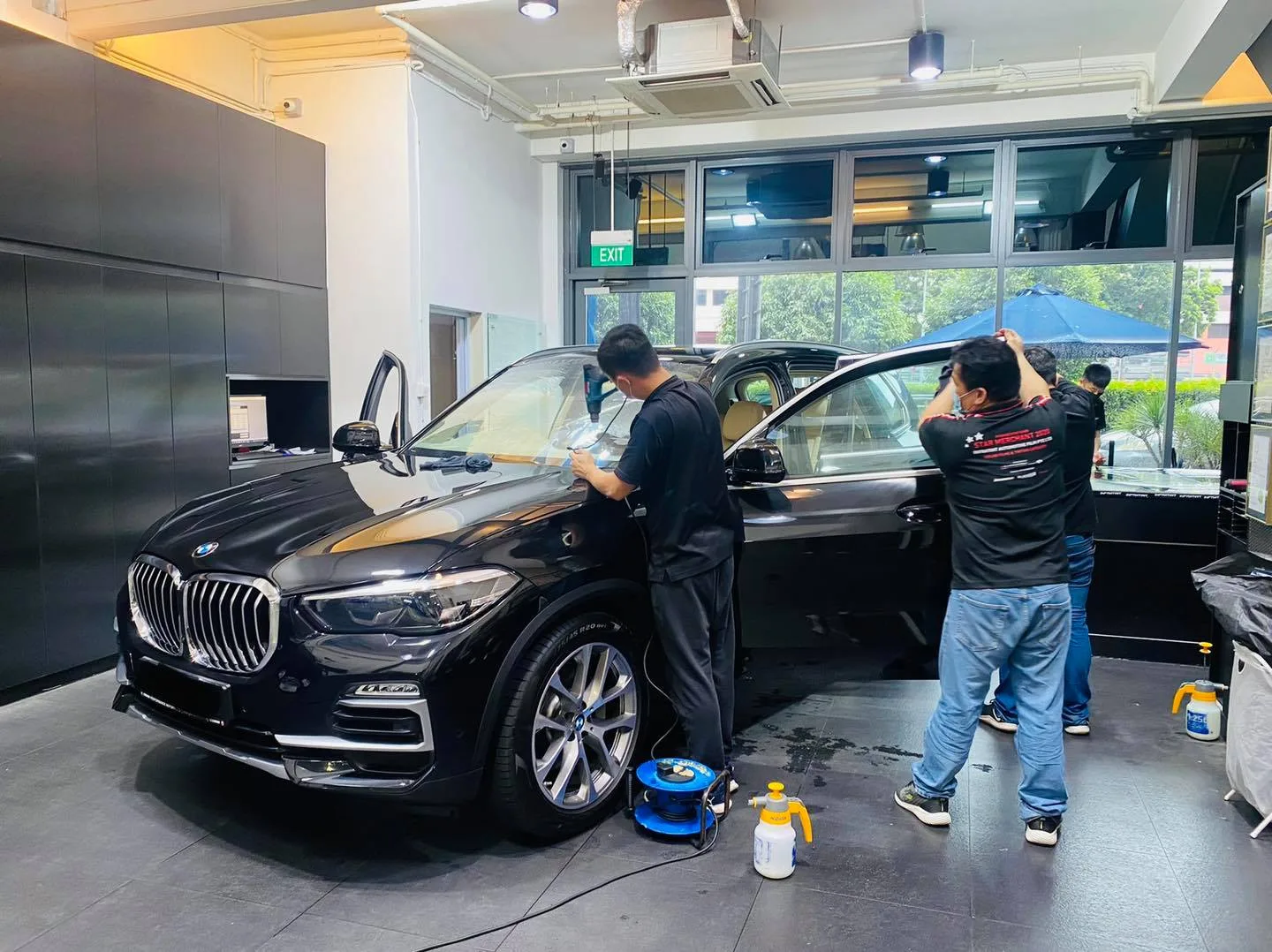 Black BMW SUV front three-quarter during window tinting at Infratint Singapore