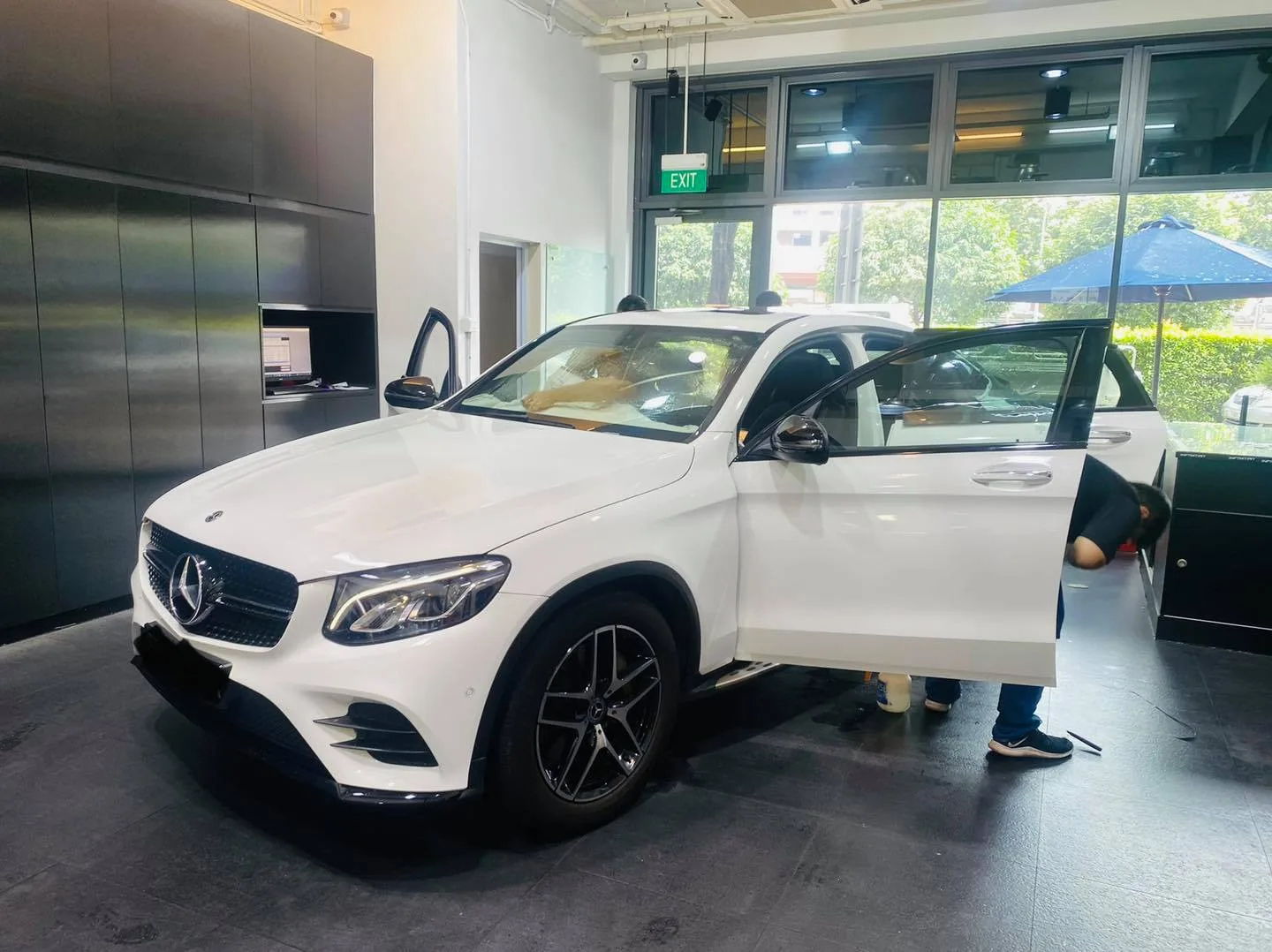 White Mercedes-Benz GLC SUV side profile during window film installation at Infratint Singapore