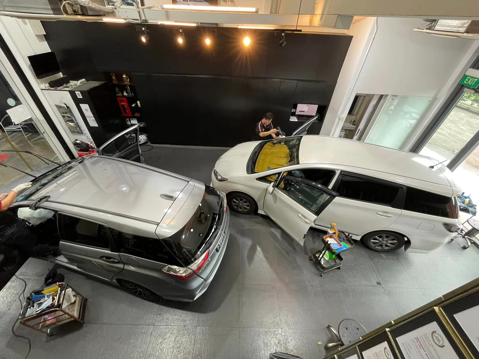 Overhead view of two silver Honda MPVs during window film install at Infratint Singapore