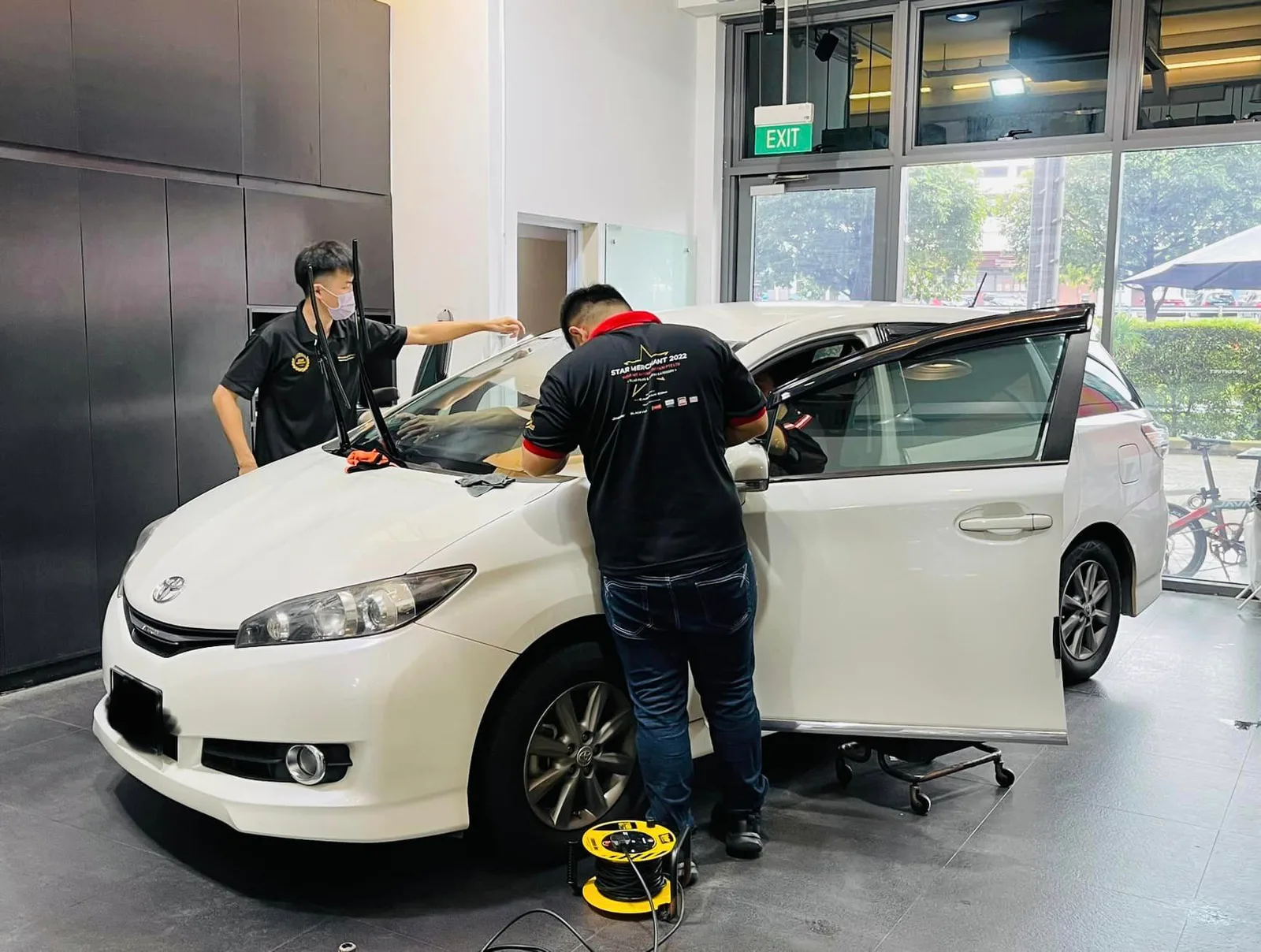 White Toyota Wish with door open during window tinting at Infratint Singapore