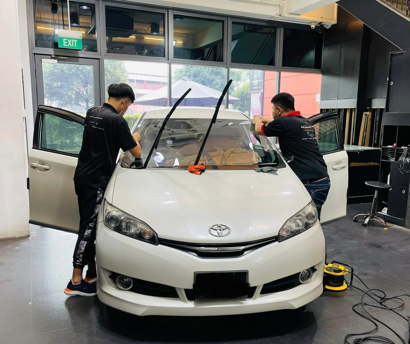 White Toyota Wish having its windscreen prepped at Infratint Singapore for window film