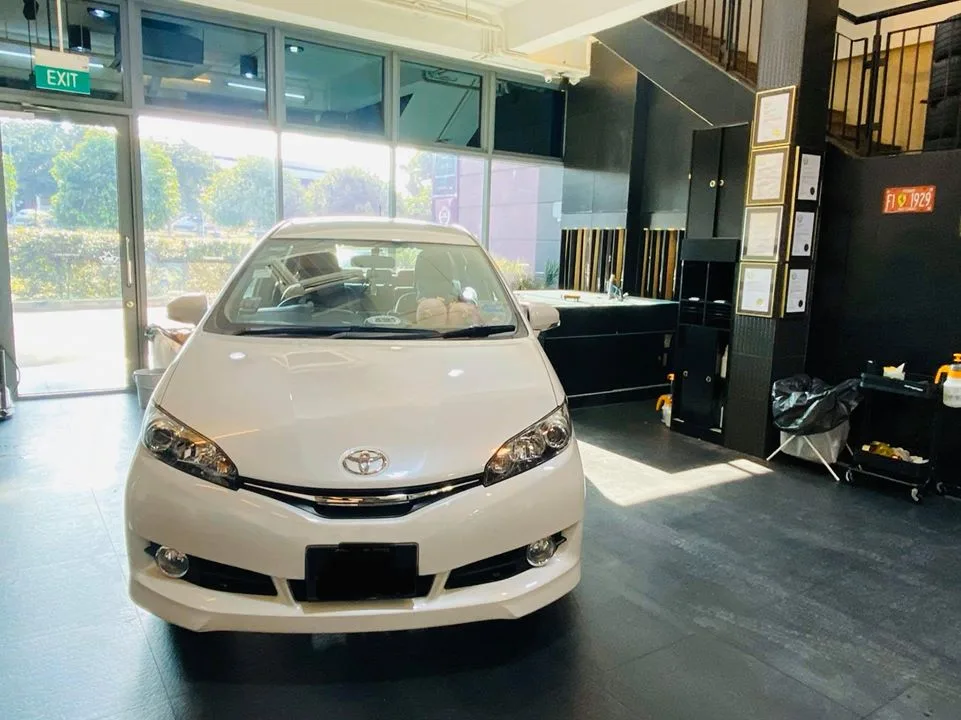White Toyota Wish front view inside the Infratint Singapore showroom for window tinting